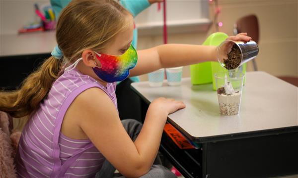 Girl makes a fossil in a cup
